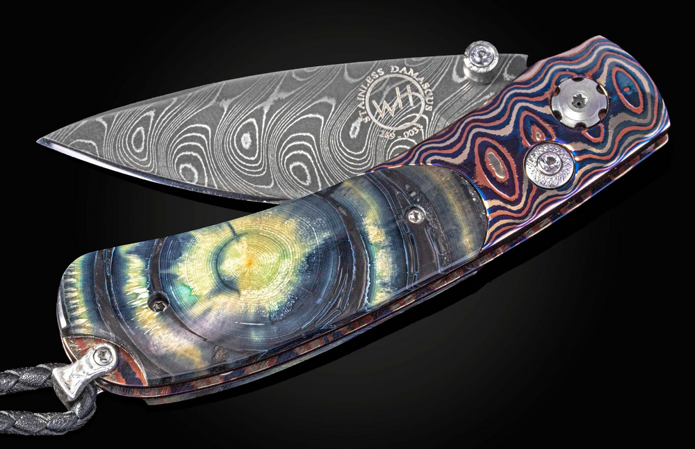 Foliding Knife Featuring Woolly Mammoth Tusk, Boomerang Damascus Steel Blade, Heat-Colored Save Mokume Frame, & White Topaz by William Henry